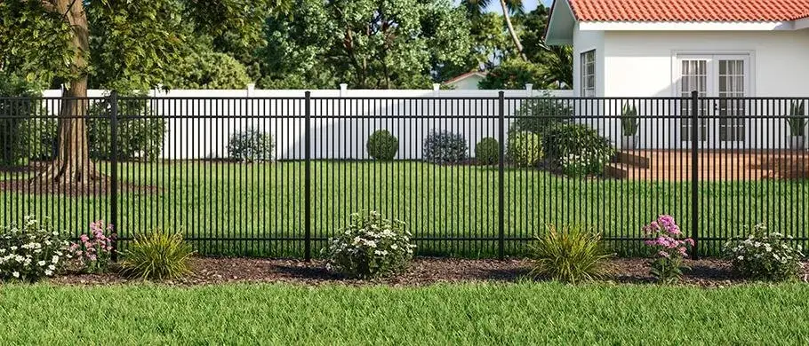 Black ornamental aluminum fence enclosing a landscaped yard